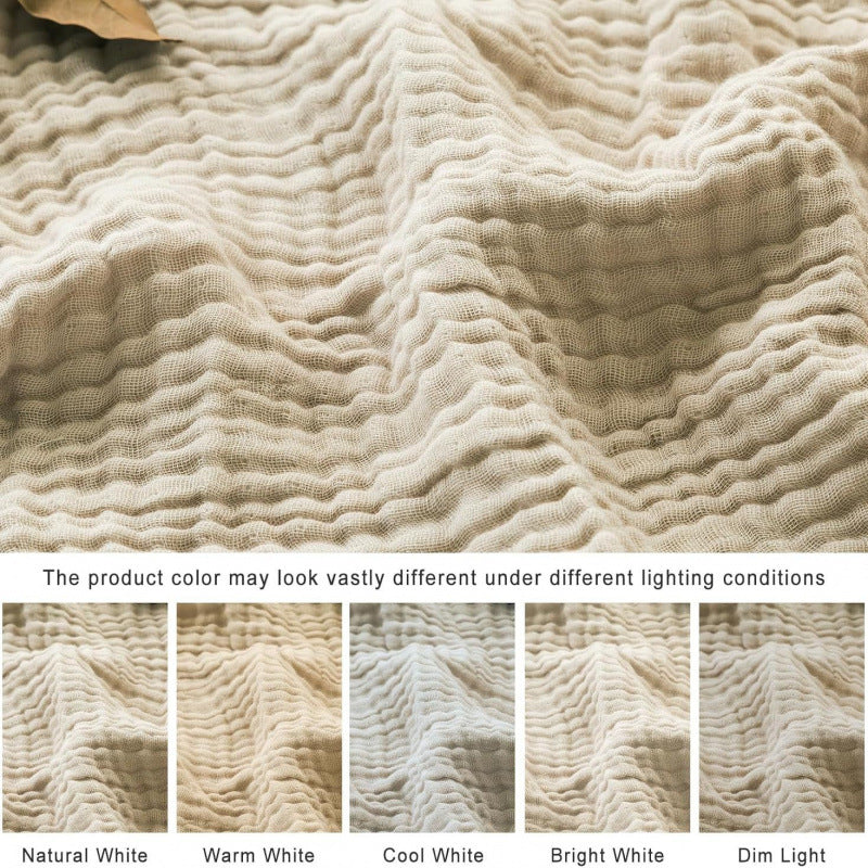 Muslin blanket layered on a sofa for lifestyle styling